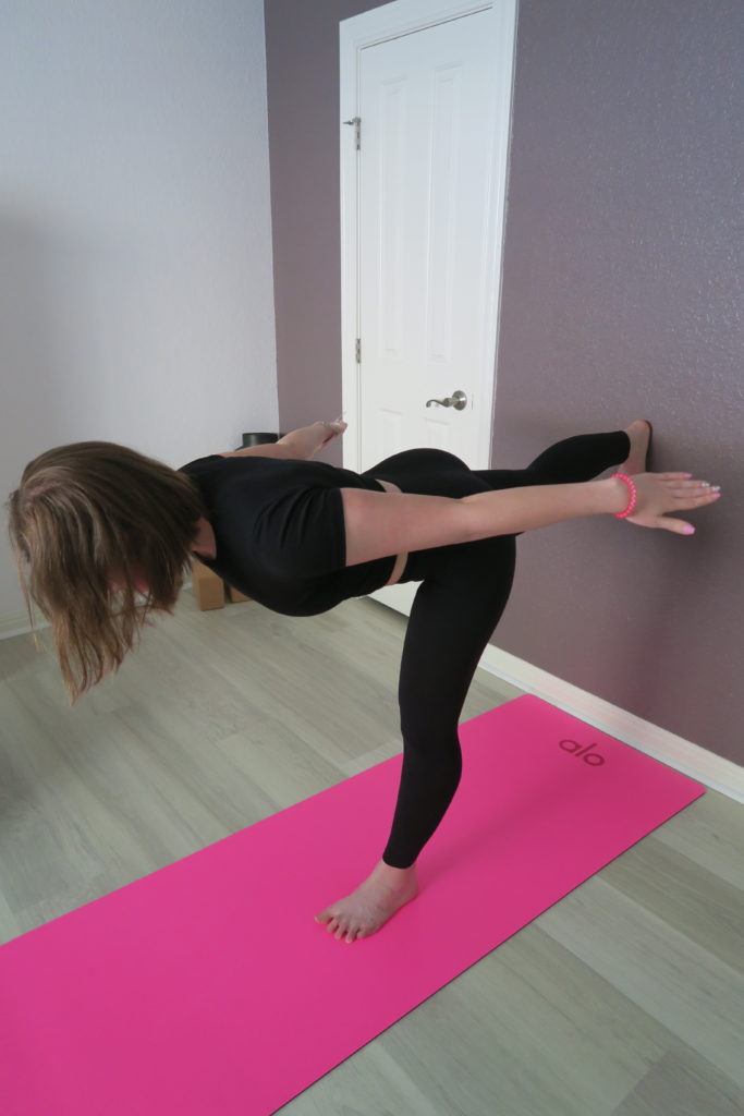 Young woman doing pincha yoga pose near the wall at home Stock Photo - Alamy